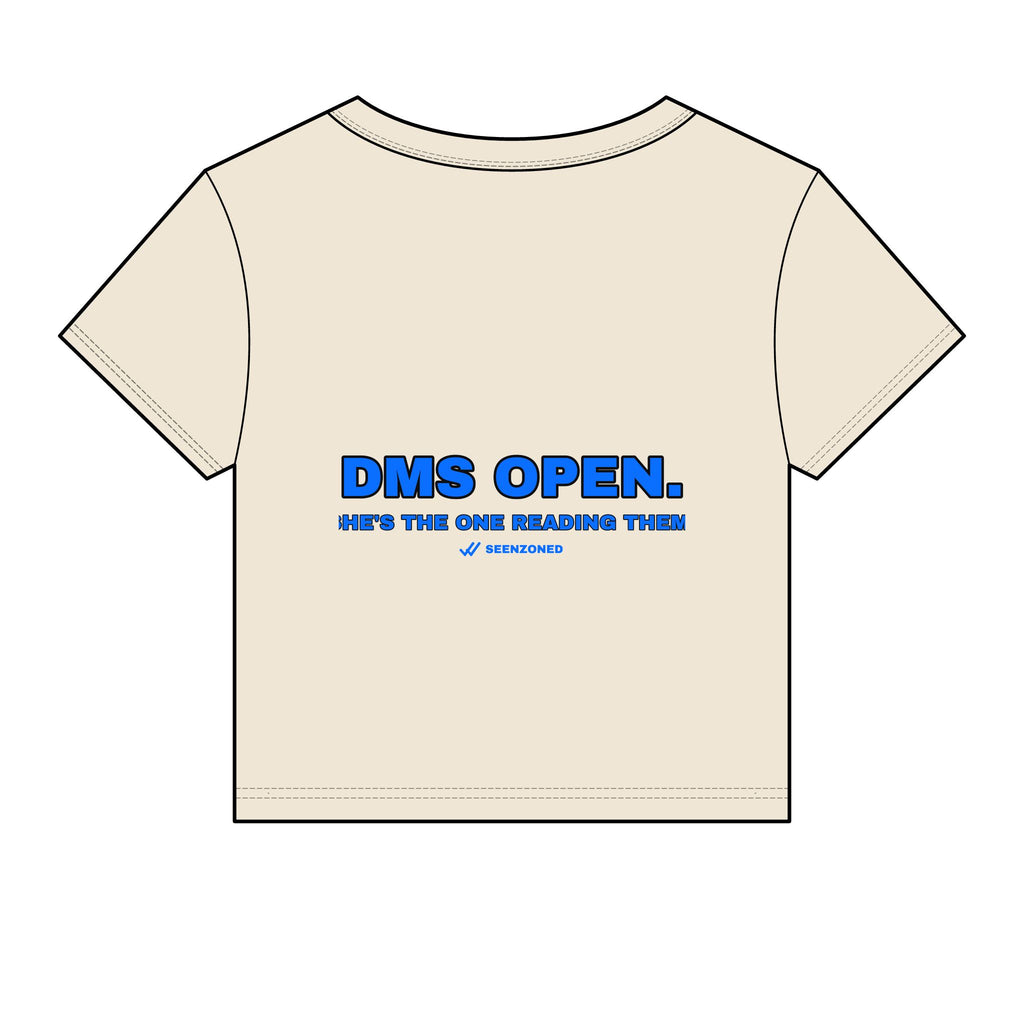 DMs open. She's the one reading them. Baby Tee